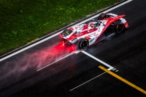 Aerial/rear shot of Norman Nato on-track in the #23 car with spray coming up from the wet track behind