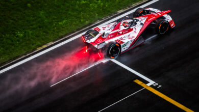 Aerial/rear shot of Norman Nato on-track in the #23 car with spray coming up from the wet track behind