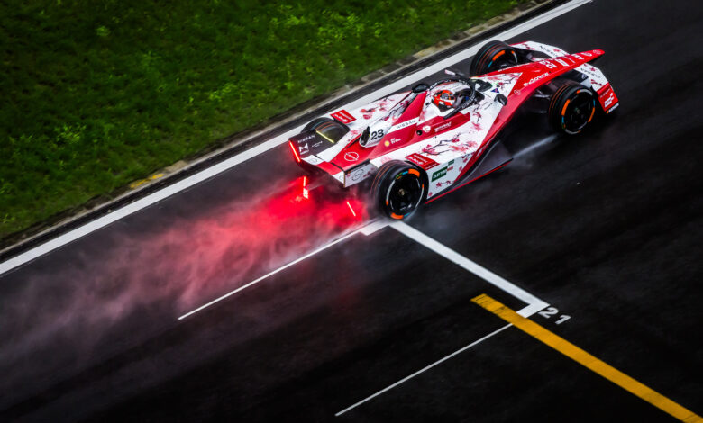 Aerial/rear shot of Norman Nato on-track in the #23 car with spray coming up from the wet track behind